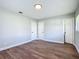 This bedroom includes wood flooring, gray paint, and has two closet doors at 220 Hillside Dr, Lakeland, FL 33803
