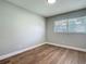 This bedroom features wood flooring and a window that provides natural light at 220 Hillside Dr, Lakeland, FL 33803