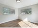 A gray bedroom has wood-look flooring and dual windows at 220 Hillside Dr, Lakeland, FL 33803