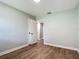 A bright bedroom boasts hard wood floors and an open doorway at 220 Hillside Dr, Lakeland, FL 33803
