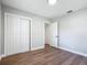 This bedroom features gray walls, wood-look flooring, and sliding closet doors at 220 Hillside Dr, Lakeland, FL 33803