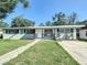 Charming single-story home with a well-manicured lawn and inviting walkway at 220 Hillside Dr, Lakeland, FL 33803