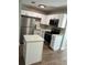 Bright kitchen features white cabinets, stainless steel appliances, and convenient island for modern living at 220 Hillside Dr, Lakeland, FL 33803