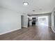 Bright living room with new hardwood floors, leading into a kitchen at 220 Hillside Dr, Lakeland, FL 33803