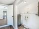 Utility room with water heater, laminate floors and white painted walls at 220 Hillside Dr, Lakeland, FL 33803