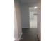 Inviting hallway with sleek wood floors leading to a bright kitchen with white cabinets at 236 Rontunda Dr, Kissimmee, FL 34758