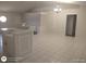 Open-concept living room features tile floors and a decorative light fixture at 236 Rontunda Dr, Kissimmee, FL 34758