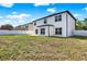 There is a large backyard with white fencing, a patio, and ample lawn space at 242 Anson Dr, Kissimmee, FL 34758