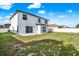 This home features a spacious backyard with a lawn and a white fence at 242 Anson Dr, Kissimmee, FL 34758