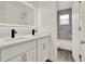 Bathroom vanity featuring dual sinks, modern faucets and lighting at 242 Anson Dr, Kissimmee, FL 34758