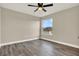 Bedroom featuring modern ceiling fan and light gray wood-look floors at 242 Anson Dr, Kissimmee, FL 34758