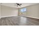 Spacious bedroom featuring modern ceiling fan and light gray wood-look floors at 242 Anson Dr, Kissimmee, FL 34758