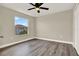 Bright bedroom with luxury vinyl plank flooring, neutral paint and updated light fixtures at 242 Anson Dr, Kissimmee, FL 34758