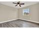 Spacious bedroom featuring modern ceiling fan and light gray wood-look floors at 242 Anson Dr, Kissimmee, FL 34758