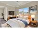 Comfortable bedroom featuring a modern bed, stylish lighting fixtures, and sleek furniture at 242 Anson Dr, Kissimmee, FL 34758