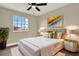 Stylish bedroom featuring a luxurious bed, elegant lighting, and a decorative window view at 242 Anson Dr, Kissimmee, FL 34758