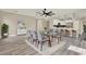 Bright dining room with gray chairs, glass table, modern light fixtures, and open floor plan at 242 Anson Dr, Kissimmee, FL 34758
