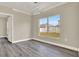 Modern dining room with wood floors, stylish lighting, and a large window for natural light at 242 Anson Dr, Kissimmee, FL 34758