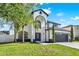 Stunning two-story home with a manicured lawn, and a spacious driveway at 242 Anson Dr, Kissimmee, FL 34758