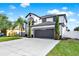 Elegant two-story home with a well-manicured lawn, and a spacious driveway at 242 Anson Dr, Kissimmee, FL 34758