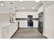 Bright kitchen featuring quartz countertops, white cabinetry, stainless steel appliances and a stylish backsplash at 242 Anson Dr, Kissimmee, FL 34758
