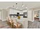 Bright kitchen with white cabinets, modern pendant lights, stainless steel appliances and quartz countertops at 242 Anson Dr, Kissimmee, FL 34758