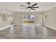 Bright living room with wood floors, ceiling fan, and sliding doors leading to the backyard at 242 Anson Dr, Kissimmee, FL 34758