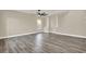 Spacious room boasting stylish gray flooring, a ceiling fan, and elegant architectural details for a welcoming atmosphere at 242 Anson Dr, Kissimmee, FL 34758