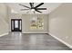 Bright living room with wood floors, ceiling fan, and large window providing ample natural light at 242 Anson Dr, Kissimmee, FL 34758