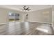 Spacious living room with wood floors, sliding doors leading to the backyard, and natural light at 242 Anson Dr, Kissimmee, FL 34758