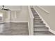 Elegant staircase with wood steps and white railing, leading to the upper level of the home at 242 Anson Dr, Kissimmee, FL 34758
