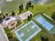 A top-down view of community amenities including a pool, playground, and sport courts by the lake at 2614 Lodi Cir # 106, Kissimmee, FL 34746
