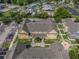 Aerial view of townhouses showing layout, parking, landscaping, and surrounding area at 2614 Lodi Cir # 106, Kissimmee, FL 34746