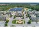 Aerial view of community featuring clubhouse, pool, lake, sport courts, and ample parking at 2614 Lodi Cir # 106, Kissimmee, FL 34746
