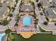 Aerial view of a community pool and clubhouse surrounded by residences and lush landscaping at 2614 Lodi Cir # 106, Kissimmee, FL 34746