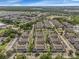 Wide aerial view of neighborhood of townhomes with ponds and many trees at 2614 Lodi Cir # 106, Kissimmee, FL 34746