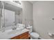 Bathroom featuring a white sink, wood vanity, and shower reflected in the mirror at 2614 Lodi Cir # 106, Kissimmee, FL 34746