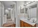 Bathroom vanity featuring wood cabinets and white sink, adjacent to carpeted hallway at 2614 Lodi Cir # 106, Kissimmee, FL 34746