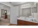 Bathroom featuring a vanity with sink, large mirror, and a combined shower and tub at 2614 Lodi Cir # 106, Kissimmee, FL 34746