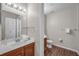 Well-lit bathroom with a wood-look vanity, white sink, and coordinated fixtures at 2614 Lodi Cir # 106, Kissimmee, FL 34746