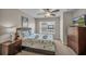 Cozy bedroom with a ceiling fan, nautically themed bedding and dresser with television at 2614 Lodi Cir # 106, Kissimmee, FL 34746