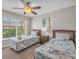 Bright bedroom offers two twin beds, ceiling fan and a view from the window at 2614 Lodi Cir # 106, Kissimmee, FL 34746