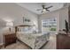 Bright bedroom features nautical themed bedding, ceiling fan and a view from the window at 2614 Lodi Cir # 106, Kissimmee, FL 34746