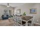 Well-lit dining area with a wooden table and white chairs, adjacent to the living space at 2614 Lodi Cir # 106, Kissimmee, FL 34746
