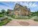 Inviting two-story home with yellow siding and a charming white picket fence at 2614 Lodi Cir # 106, Kissimmee, FL 34746