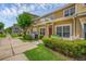 Townhouse with yellow siding, white trim, well-maintained landscaping and manicured lawn at 2614 Lodi Cir # 106, Kissimmee, FL 34746