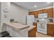 Functional kitchen featuring white appliances, tile flooring, and ample counter space at 2614 Lodi Cir # 106, Kissimmee, FL 34746