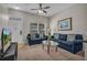 Cozy living room with comfortable seating, ceiling fan, and bright natural light at 2614 Lodi Cir # 106, Kissimmee, FL 34746