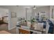 Open-concept dining and living space featuring comfortable furniture and a view into a bedroom at 2614 Lodi Cir # 106, Kissimmee, FL 34746
