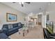 Open-concept living area with sofas, a glass table, and a combined dining space and kitchen at 2614 Lodi Cir # 106, Kissimmee, FL 34746
